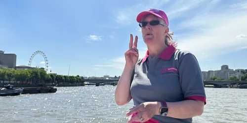 Person speaking signing language on the river thames
